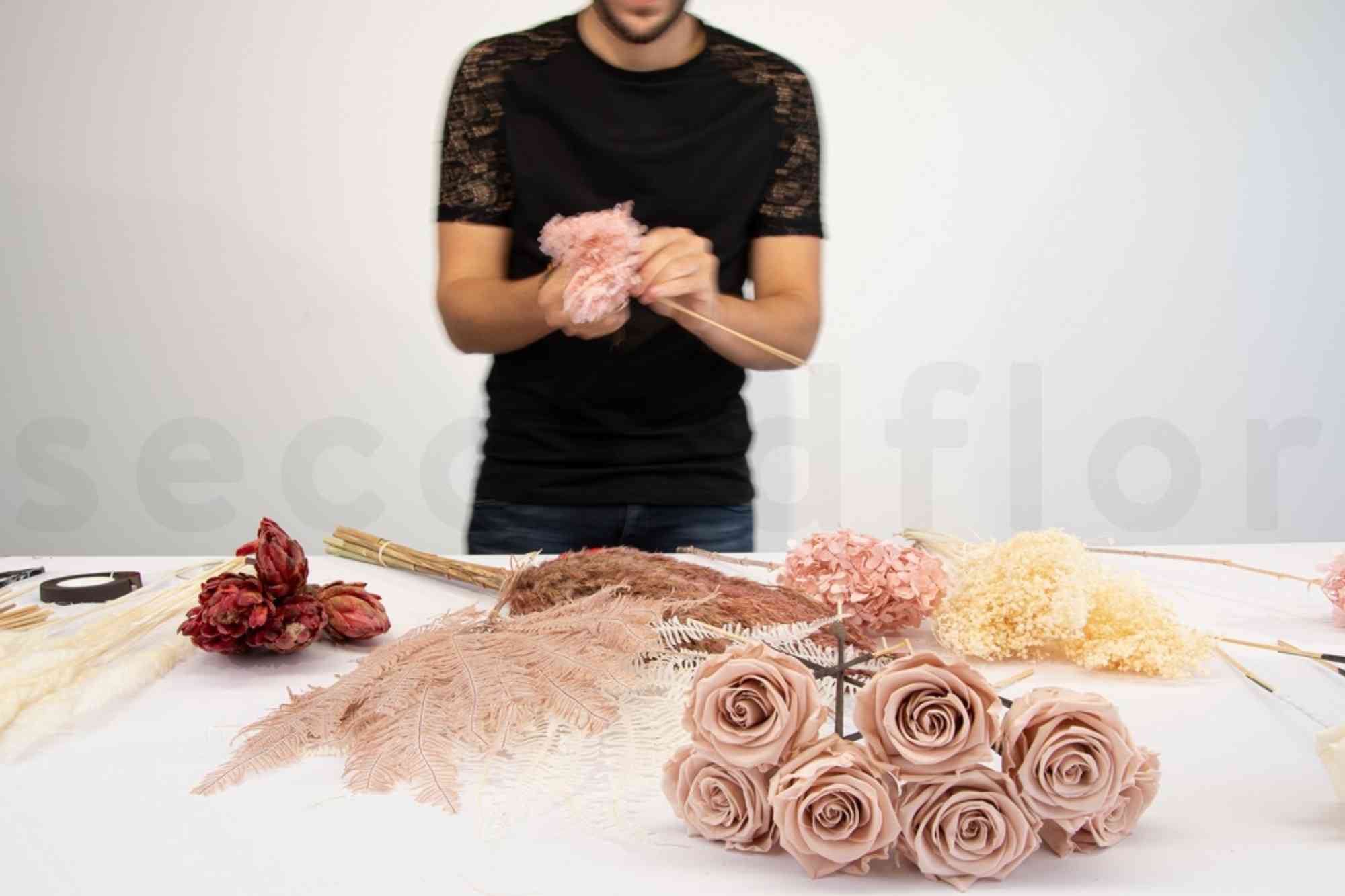 florist picking the hydrangea and holding it as the base of the bouquet